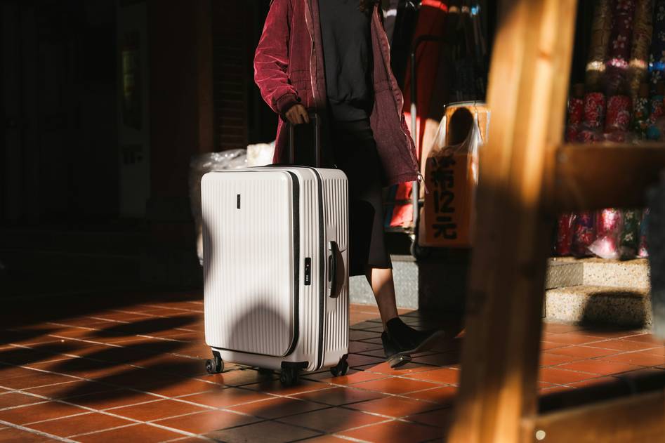 Stylish carry-on luggage set with gold hardware on neutral backdrop