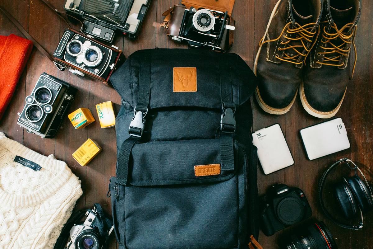 Professional influencer using rugged luggage for multiple camera bodies at airport security checkpoint